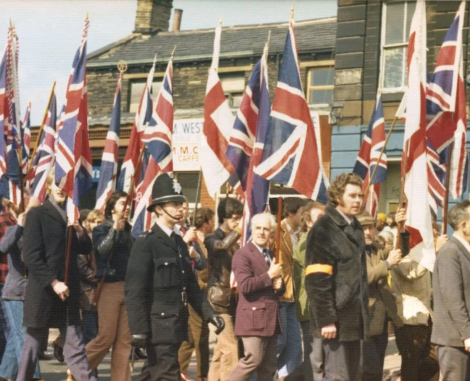 Historical image of rally carrying Union Jacks